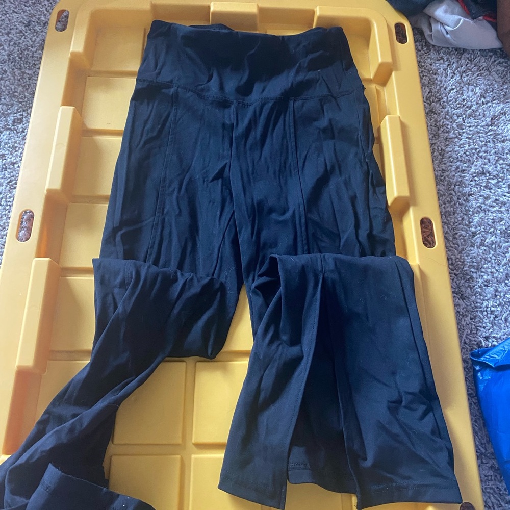 Black flared, slit leggings. Size is small but fits tighter